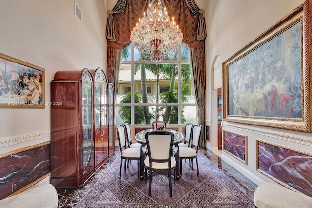 dining space with a notable chandelier and a high ceiling