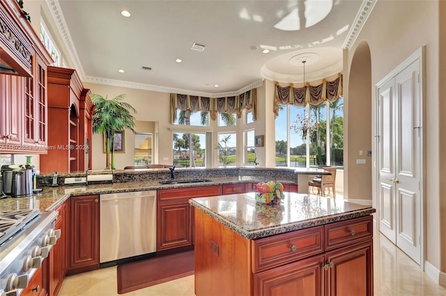 kitchen with kitchen peninsula, a kitchen island, stone countertops, and appliances with stainless steel finishes