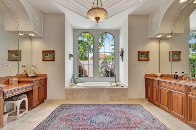 bathroom with vanity and a relaxing tiled tub