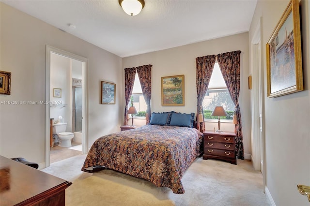 bedroom featuring light colored carpet, connected bathroom, and multiple windows