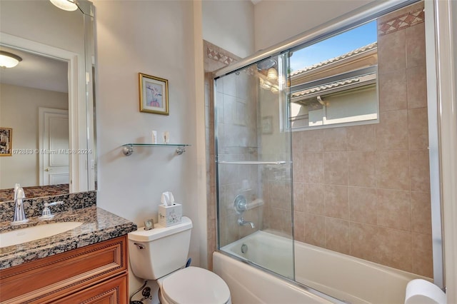 full bathroom with vanity, toilet, and bath / shower combo with glass door