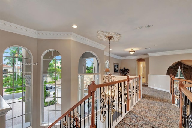 hall with ornamental molding and carpet floors