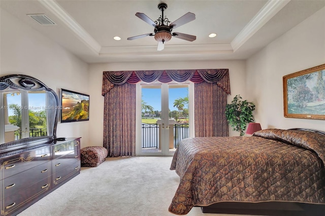 bedroom with ceiling fan, a raised ceiling, access to outside, and multiple windows