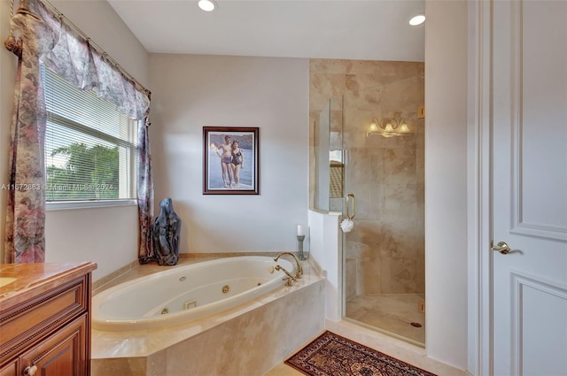 bathroom with separate shower and tub and vanity