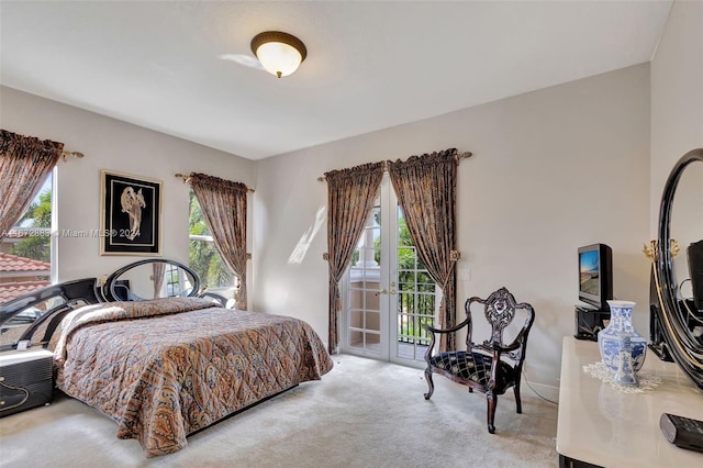 carpeted bedroom featuring access to exterior and french doors