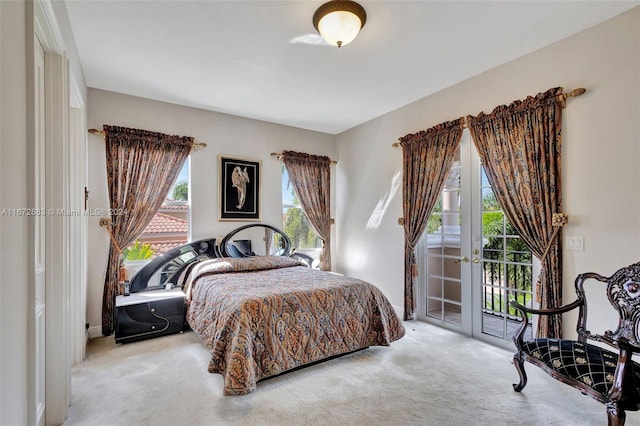 bedroom featuring access to exterior and light carpet