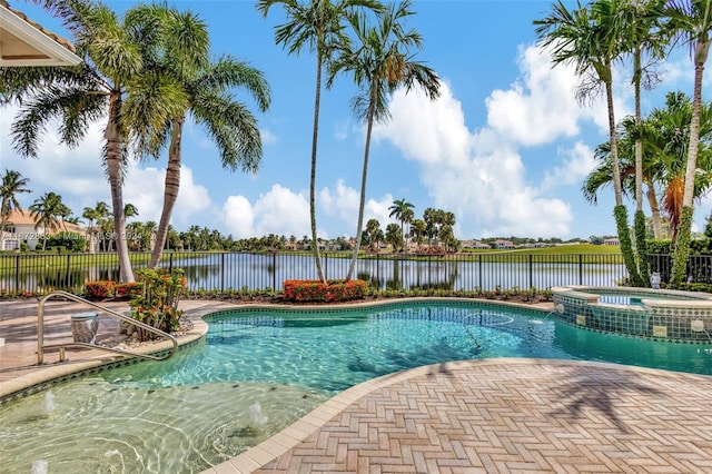 view of pool with an in ground hot tub and a water view