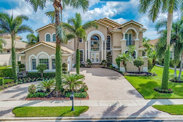 mediterranean / spanish-style home with french doors and a front yard