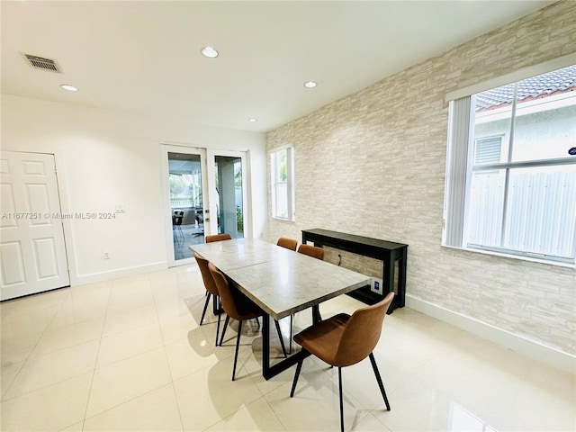 dining area with light tile patterned floors and a healthy amount of sunlight