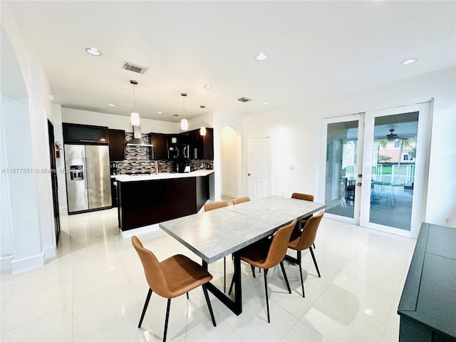 tiled dining space featuring ceiling fan