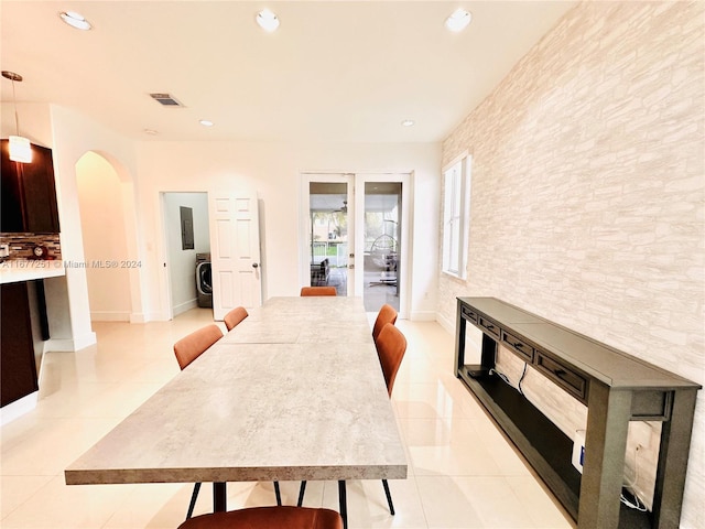 dining room featuring washer / clothes dryer and light tile patterned flooring