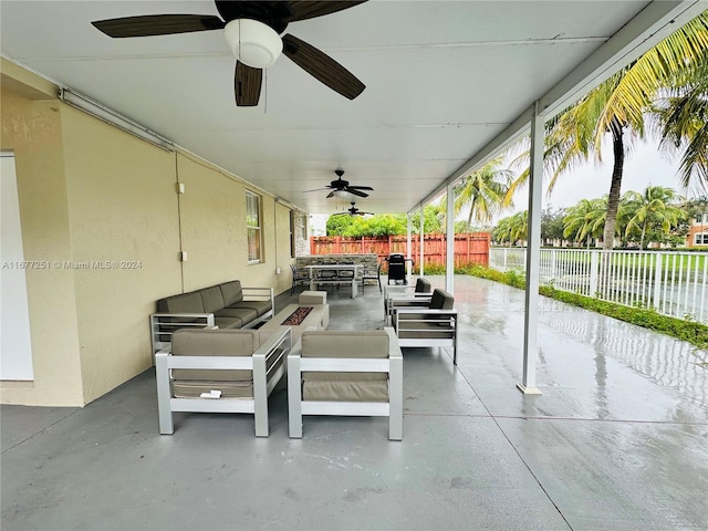 view of patio / terrace with an outdoor living space with a fire pit