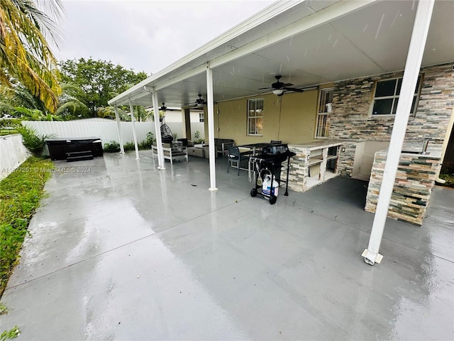 view of patio with ceiling fan and area for grilling