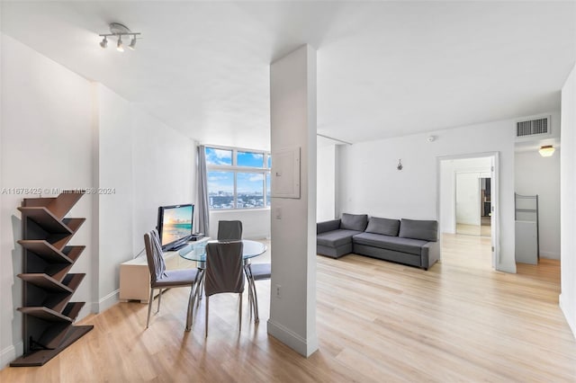 dining space with light wood-type flooring