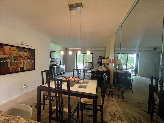 dining room featuring vaulted ceiling and carpet flooring