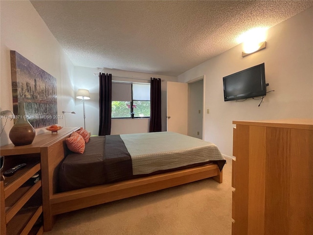 bedroom featuring carpet flooring and a textured ceiling