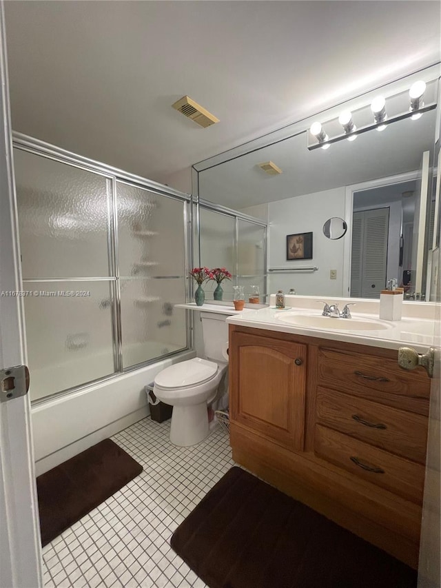 full bathroom with visible vents, tile patterned flooring, vanity, toilet, and bath / shower combo with glass door