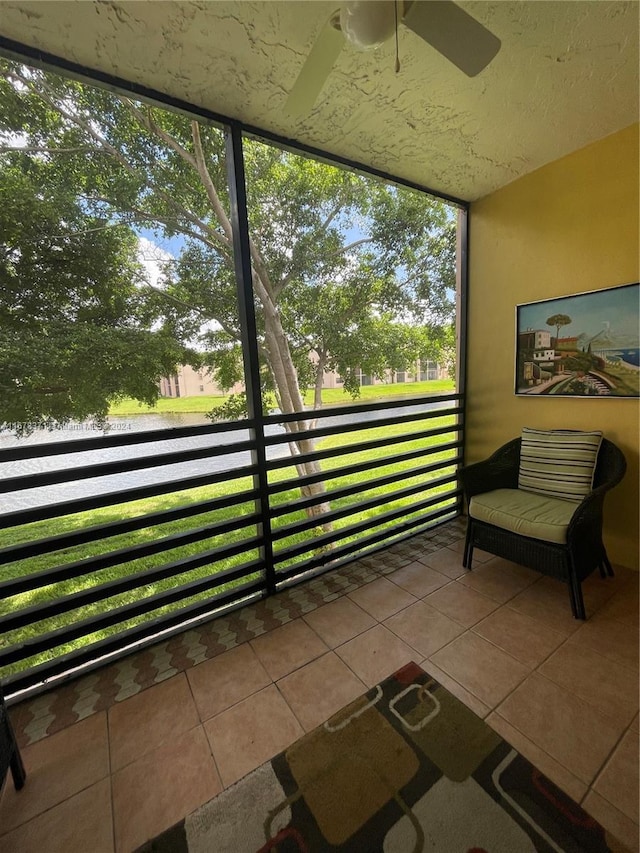 sunroom featuring a ceiling fan