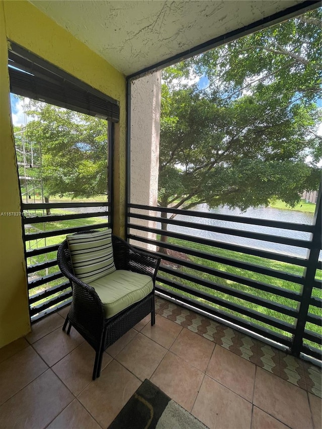 sunroom / solarium featuring a water view and plenty of natural light