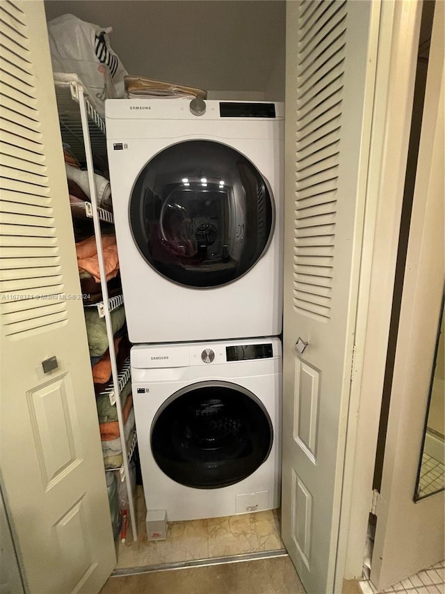 laundry room with laundry area and stacked washer / dryer