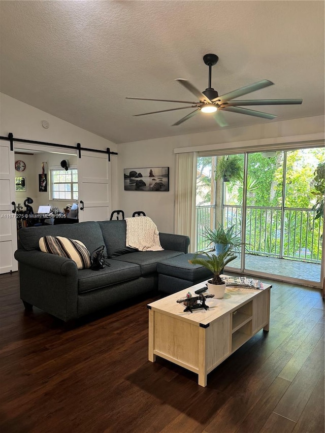 421 SE 10th St Unit A205, Dania Beach, FL 33004 - living room featuring a barn door, a ceiling fan, dark wood finished floors, vaulted ceiling, and a textured ceiling