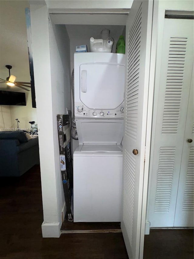 washroom with stacked washer / drying machine, dark hardwood / wood-style flooring, and ceiling fan