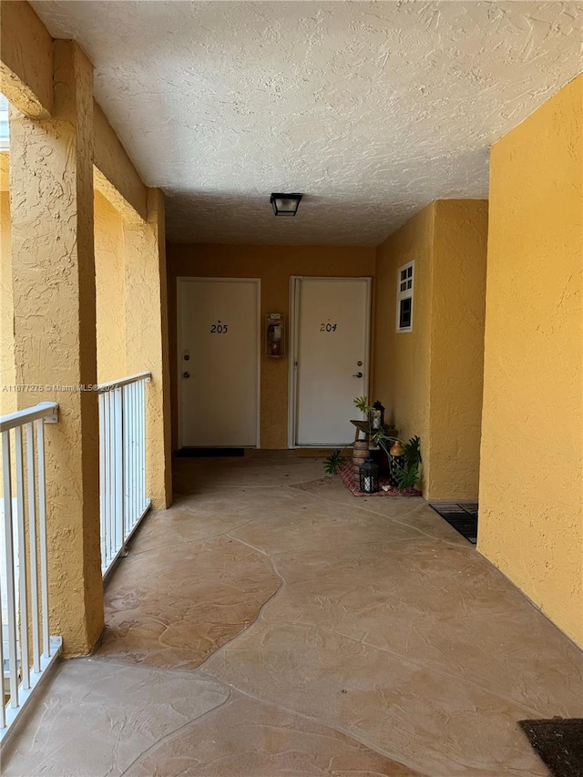 corridor with a textured ceiling