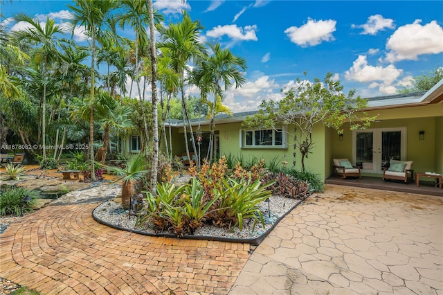 rear view of house with a patio, ceiling fan, and french doors