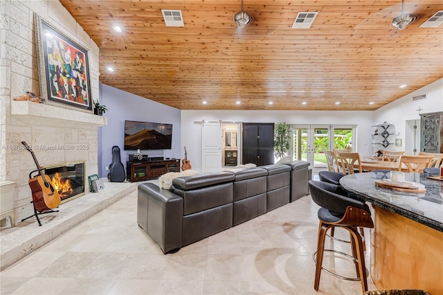 living room with lofted ceiling, wood ceiling, a fireplace, and french doors