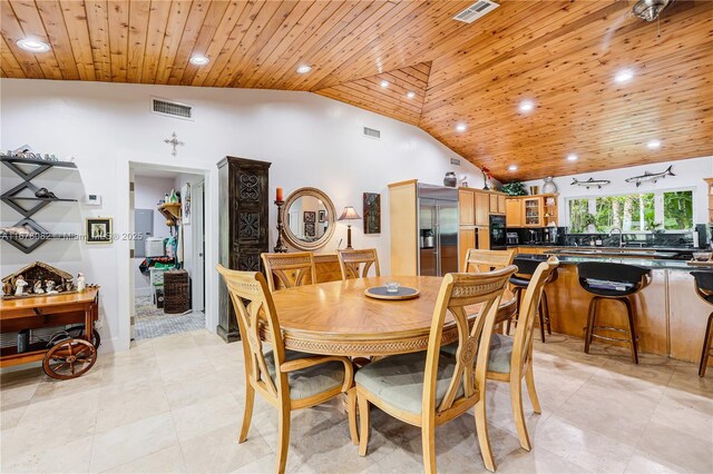 dining room featuring high vaulted ceiling and wooden ceiling