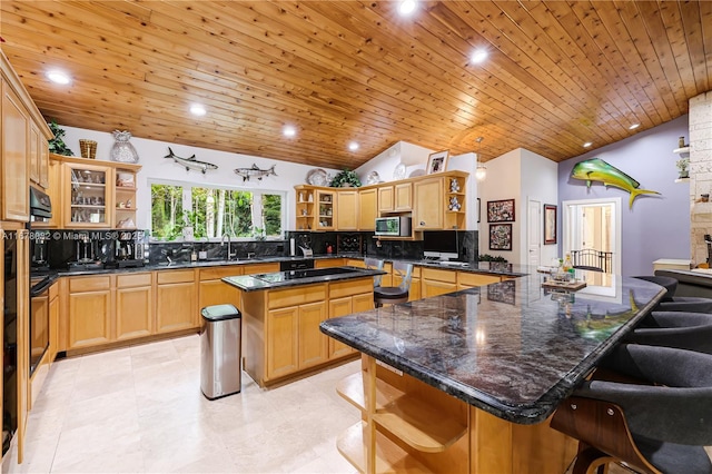 kitchen featuring tasteful backsplash, a kitchen island, a breakfast bar, and wooden ceiling