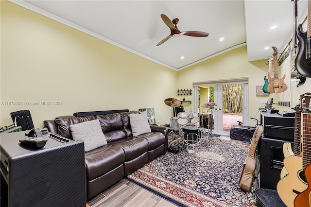 living room with crown molding, ceiling fan, vaulted ceiling, and light hardwood / wood-style floors