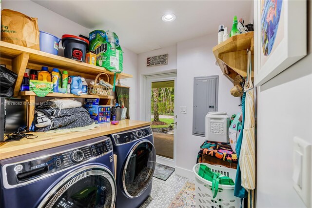 washroom with electric panel and washer and clothes dryer