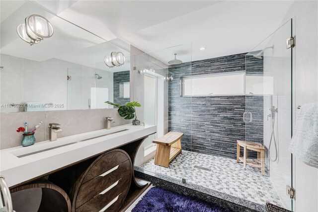 bathroom with tasteful backsplash, vanity, and a shower with shower door