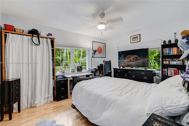 bedroom with ceiling fan and light hardwood / wood-style flooring