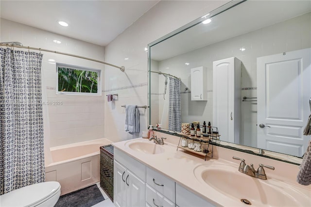 full bathroom with vanity, shower / bath combo, and toilet