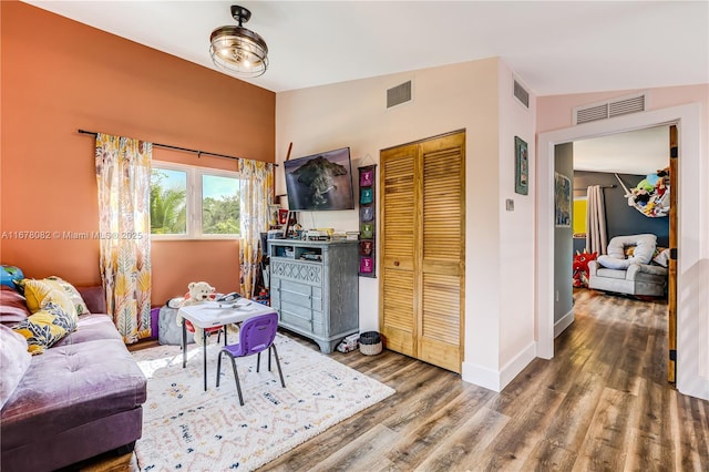 living room with hardwood / wood-style flooring and lofted ceiling