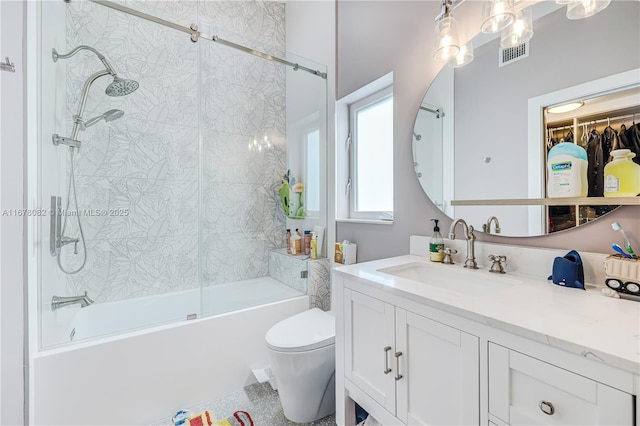 full bathroom with vanity, tiled shower / bath, and toilet