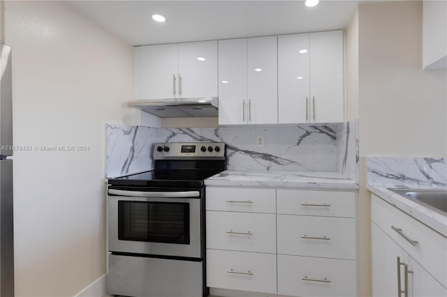 kitchen featuring white cabinetry, tasteful backsplash, light stone countertops, and stainless steel range with electric cooktop