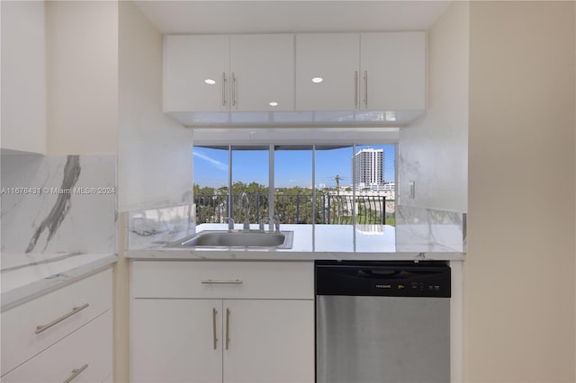 kitchen with sink, dishwasher, and white cabinets