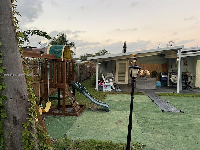 playground at dusk with a lawn and a patio