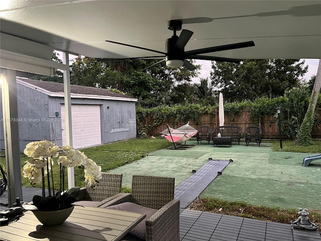 view of yard featuring an outbuilding, a garage, and ceiling fan