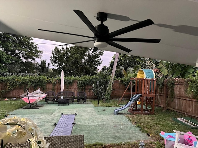 view of jungle gym featuring a yard and ceiling fan