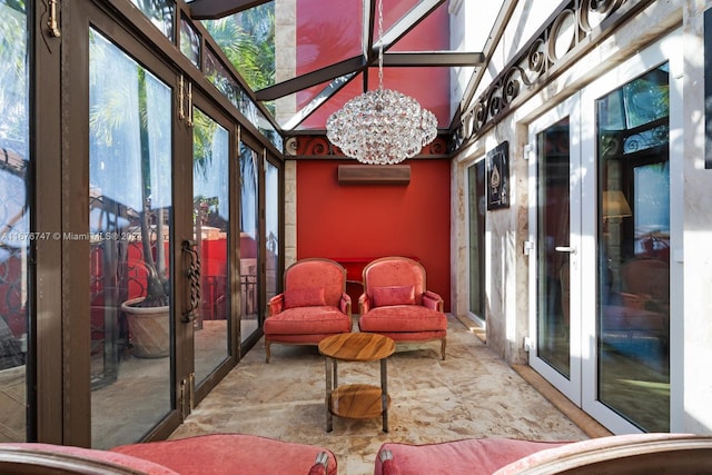 sunroom / solarium featuring a notable chandelier and a wall unit AC