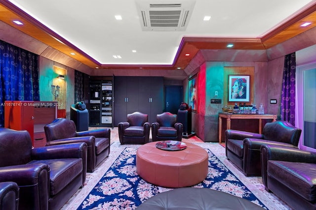 carpeted home theater with a tray ceiling