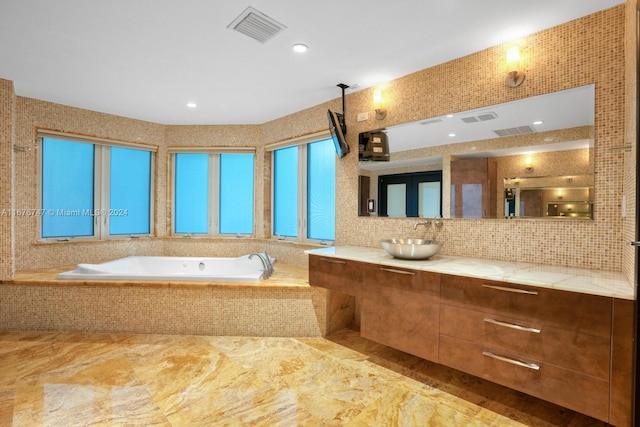 bathroom with vanity and tiled bath