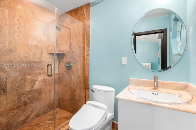 bathroom featuring vanity, toilet, and an enclosed shower