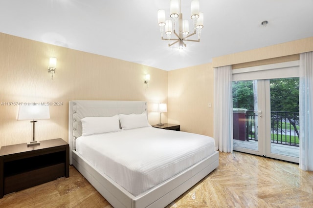 bedroom with light parquet floors, access to outside, and an inviting chandelier