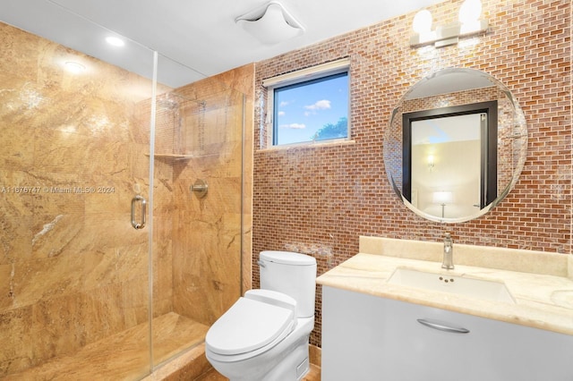 bathroom with vanity, toilet, and a shower with shower door