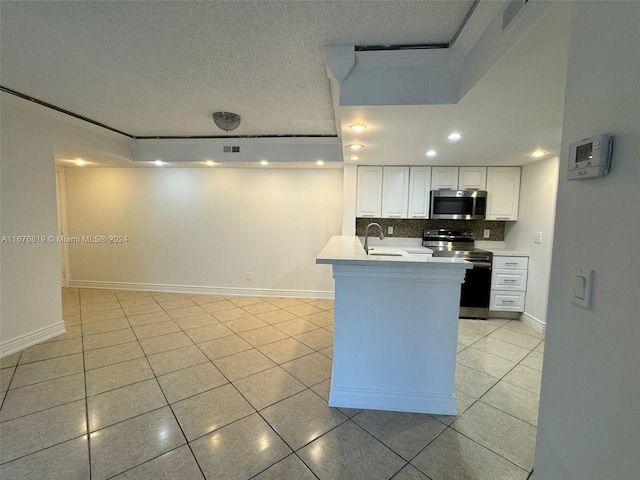 kitchen featuring decorative backsplash, stainless steel appliances, light tile patterned flooring, white cabinetry, and a textured ceiling